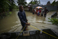 Indian army personnel rescue flood affected villagers on a boat in Jalimura village, west of Gauhati, India, Saturday, June 18, 2022. More than a dozen people have died as massive floods ravaged northeastern India and Bangladesh, leaving millions of homes underwater and severing transport links, authorities said Saturday. (AP Photo/Anupam Nath)