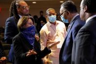 Senator Amy Klobuchar talks with civil rights activist Reverend Jesse Jackson during a memorial service for George Floyd following his death in Minneapolis police custody, in Minneapolis, in Minneapolis