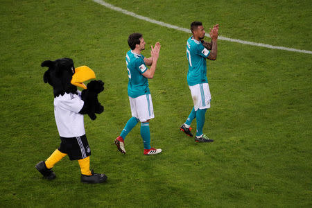 Soccer Football - International Friendly - Germany vs Spain - ESPRIT arena, Dusseldorf, Germany - March 23, 2018 Germany’s Jerome Boateng, Mats Hummels and the mascot applaud their fans after the match REUTERS/Wolfgang Rattay