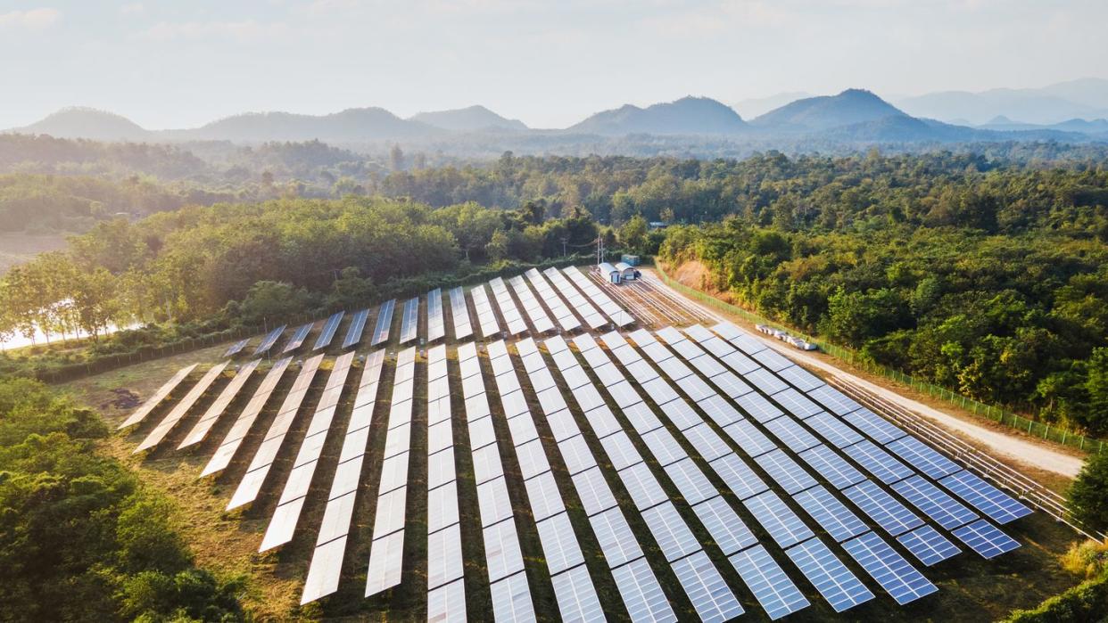 aerial view of the solar power plant on the mountain at sunset