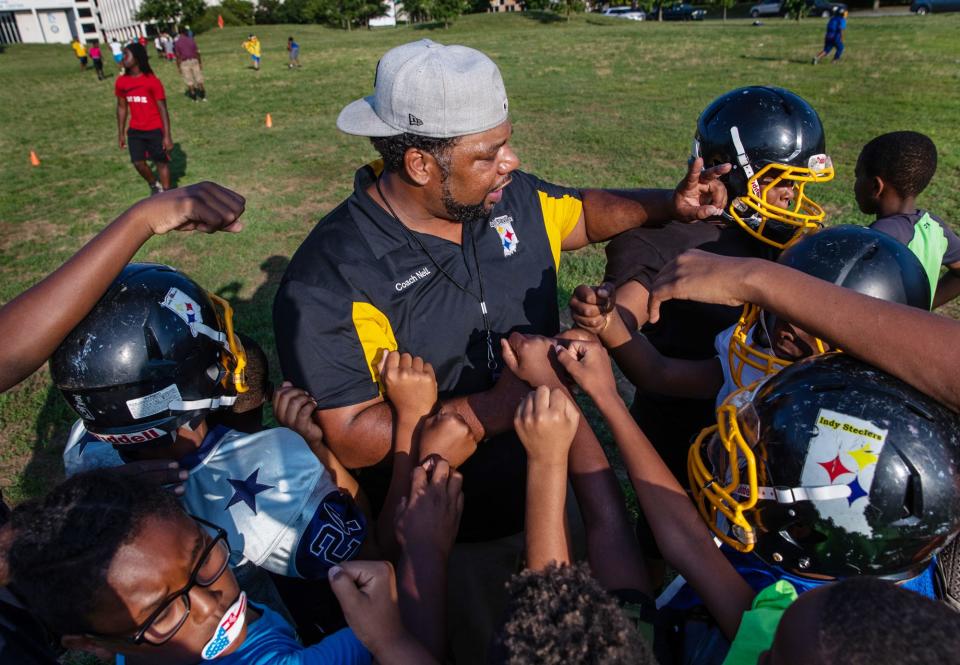 Indy Steelers coach and founder Donnell Hamilton talks with the 11u team during practice at Tarkington Park on Tuesday, July 23, 2019.