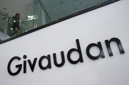 FILE PHOTO: An employee walks down the stairs at Givaudan's perfumery school in Singapore January 7, 2016. REUTERS/Edgar Su/File Photo