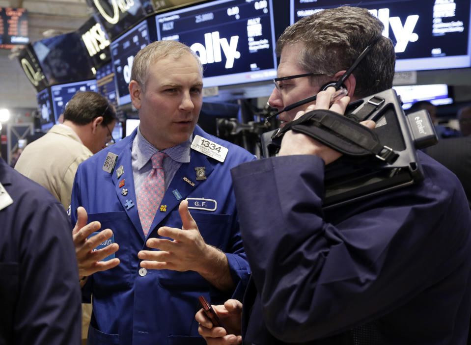 Specialist Geoffrey Friedman, left, and trader Sean Spain work on the floor of the New York Stock Exchange Thursday, April 10, 2014. U.S. stock indexes are slipping lower in early trading Thursday as investors pick over a mixed batch of corporate earnings reports. (AP Photo/Richard Drew)