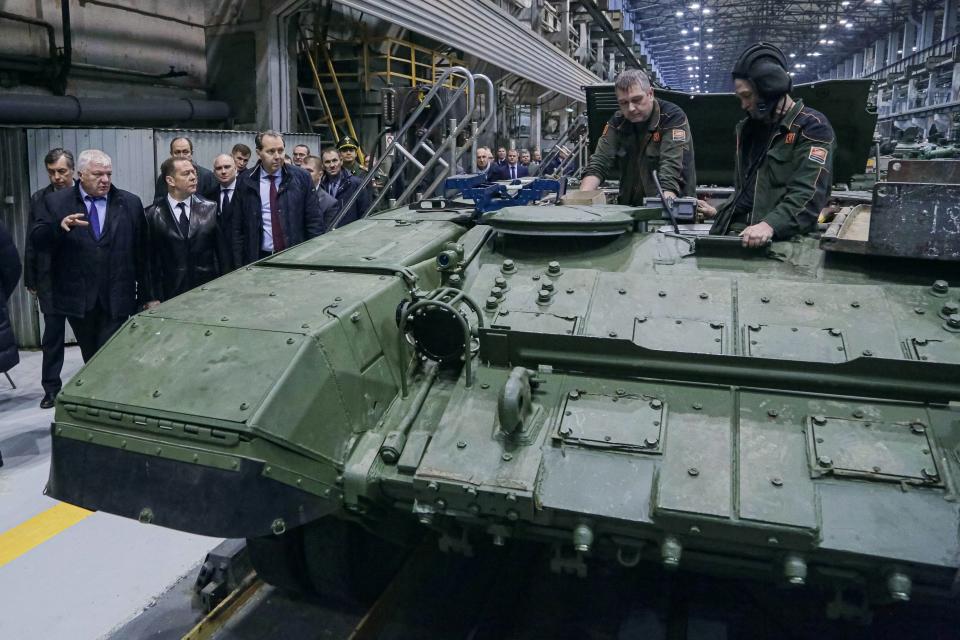 FILE - Deputy Chairman of the Russian Security Council Dmitry Medvedev, second left, accompanied by Russian Presidential Envoy to Ural Federal District Vladimir Yakushev, left, visits the Uralvagonzavod factory in Nizhny Tagil in Nizhny Tagil, Russia, on Oct. 24, 2022. Russia has weathered sweeping Western economic sanctions better than many expected. (Ekaterina Shtukina, Sputnik, Government Pool Photo via AP, File)