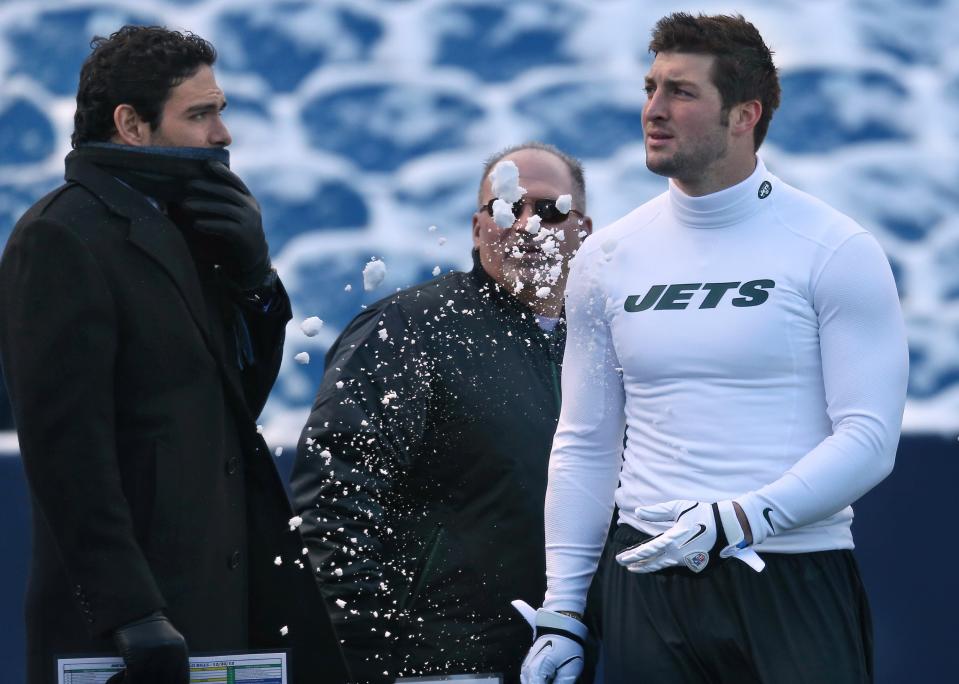 Tim Tebow #15 of the New York Jets throws snow in the direction of Mark Sanchez #6 as offensive coordinator Tony Sparano looks on before their NFL game against the Buffalo Bills at Ralph Wilson Stadium on December 30, 2012 in Orchard Park, New York. (Photo by Tom Szczerbowski/Getty Images)