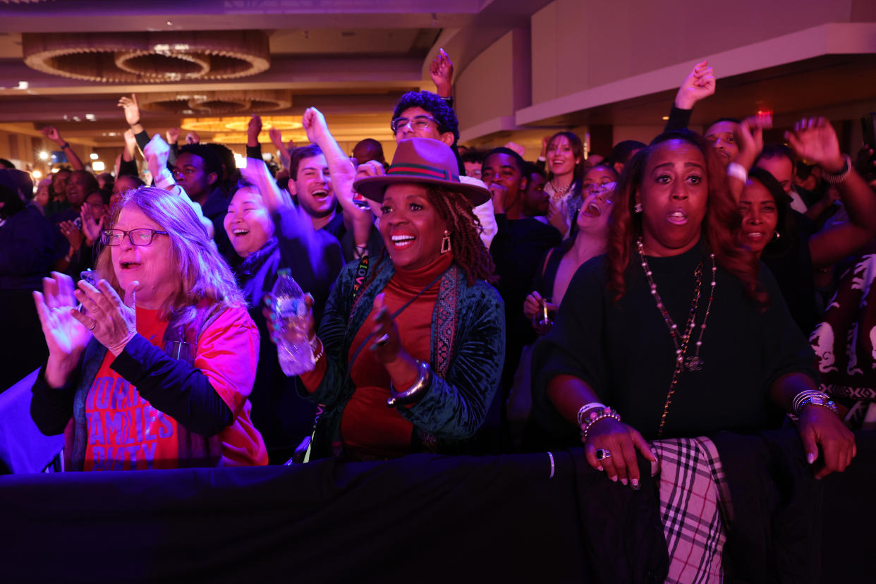 Supporters at an election night party for Warnock.