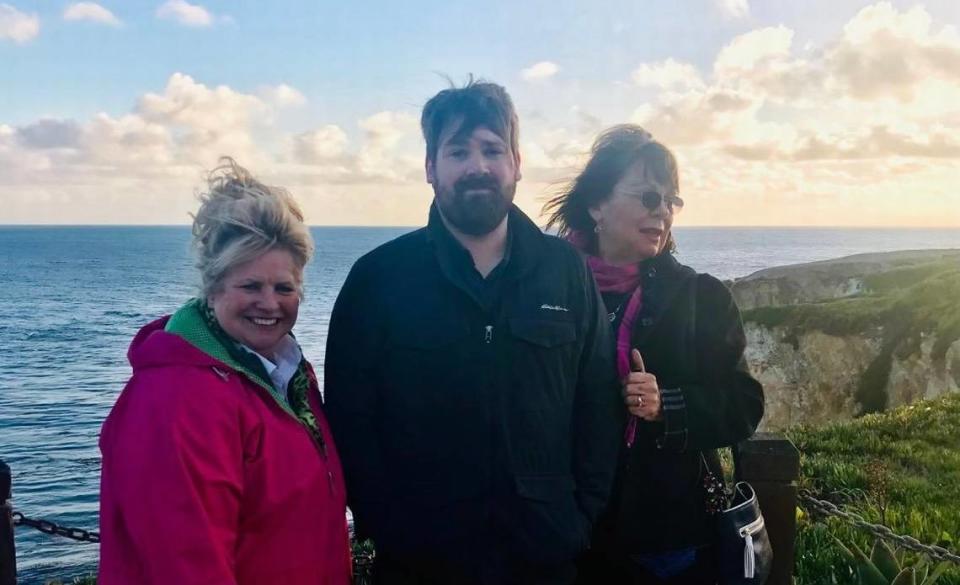 Chris Lambert, center, with Denise Smart, right, and another member of the Jam Fam on Feb. 20, 2019, at the bench in Margo Dodd Park in Shell Beach.