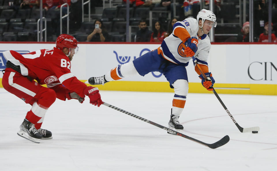 New York Islanders left wing Anthony Beauvillier (18) takes a shot on goal against Detroit Red Wings defenseman Jordan Oesterle (82) during the second period of an NHL hockey game Saturday, Dec. 4, 2021, in Detroit. (AP Photo/Duane Burleson)