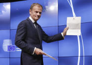 EU Council President Donald Tusk grimaces at a press conference in Brussels, Belgium, Wednesday, March 29, 2017 showing the letter he received signed by Britain's Prime Minister Theresa May formally triggered the beginning of Britain's exit from the European Union. ((AP Photo/Olivier Matthys)