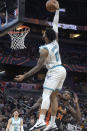 Charlotte Hornets forward Miles Bridges (0) goes up for a dunk in front of Orlando Magic center Wendell Carter Jr. (34) during the first half of an NBA basketball game, Wednesday, Nov. 24, 2021, in Orlando, Fla. (AP Photo/Phelan M. Ebenhack)