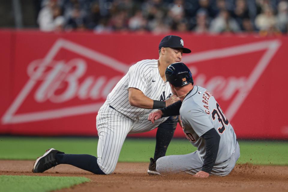 Detroit Tigers right fielder Kerry Carpenter (30) is tagged out by New York Yankees shortstop Anthony Volpe (11) during the sixth inning at Yankee Stadium in New York on Friday, May 3, 2024.