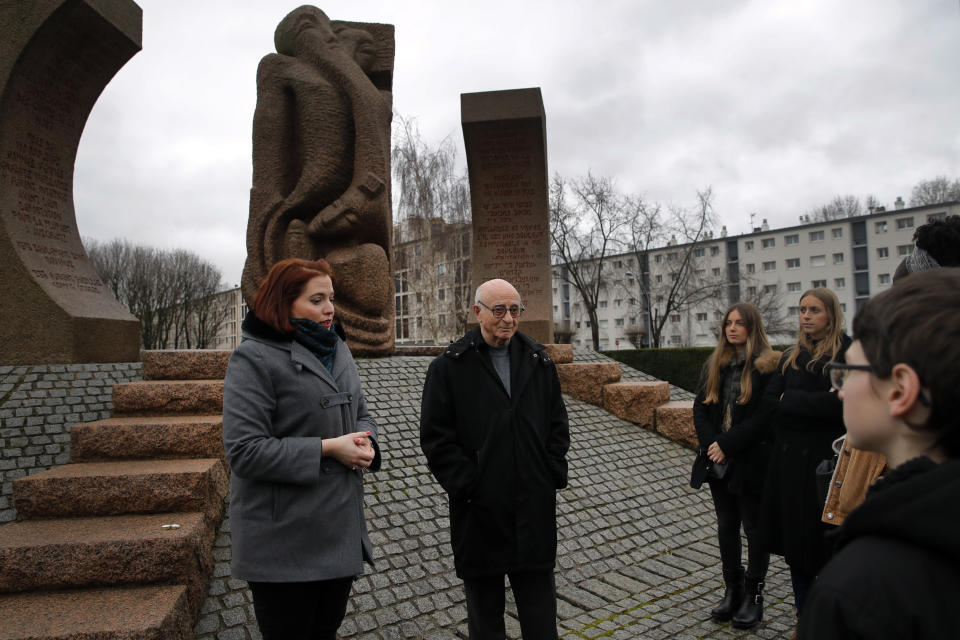 In this photo taken on Thursday Jan. 30, 2020, Victor Perahia, interned as a child in the Drancy camp and deported to Bergen-Belsen speaks to students during a workshop dedicated to the Holocaust remembrance at the Drancy Shoah memorial, outside Paris. French Holocaust survivor Victor Perahia was 9 when his family was seized by the Nazis, but couldn't bear to speak about what happened for 40-years, but is now telling his story to schoolchildren at Drancy, backdropped by the buildings that once imprisoned him. (AP Photo/Christophe Ena)