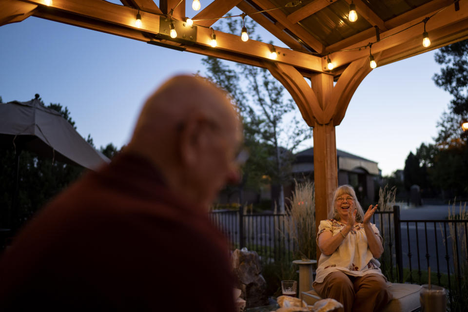 Sandy Phillips, right, laughs while talking with her husband, Lonnie, outside a friend's home where they're staying in Lone Tree, Colo., Tuesday, Sept. 5, 2023, during a visit to the United States. Since Sandy's daughter, Jessica Ghawi, was killed in a 2012 mass shooting in a movie theater, the pace of other mass killings only intensified. Instead of tighter gun laws, some states loosened them. Exhausted, disgusted and impoverished, the Phillips recently moved to Mexico. (AP Photo/David Goldman)