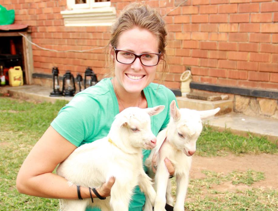 Renee Bach pictured holding two baby goats in 2014. Ms Bach is accused of misrepresenting herself as a doctor to mothers in Uganda and taking malnourished kids into her care. She's a member of Serving His Children but it's alleged she's responsible for deaths of more than 100 children in her care.