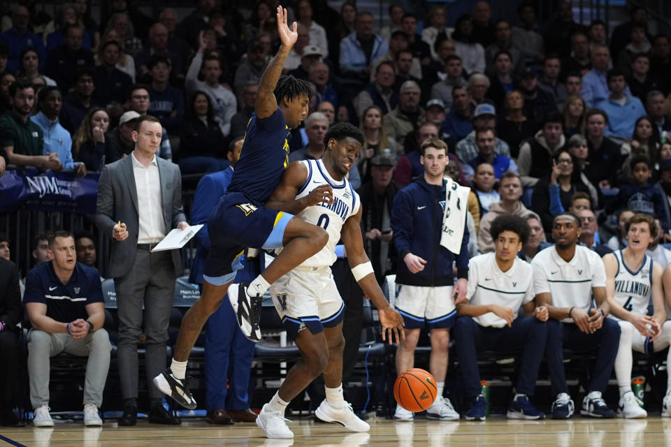 Villanova's TJ Bamba, right, tries to keep away form Marquette's Zaide Lowery during the second half of an NCAA college basketball game, Tuesday, Jan. 30, 2024, in Villanova, Pa. (AP Photo/Matt Slocum)