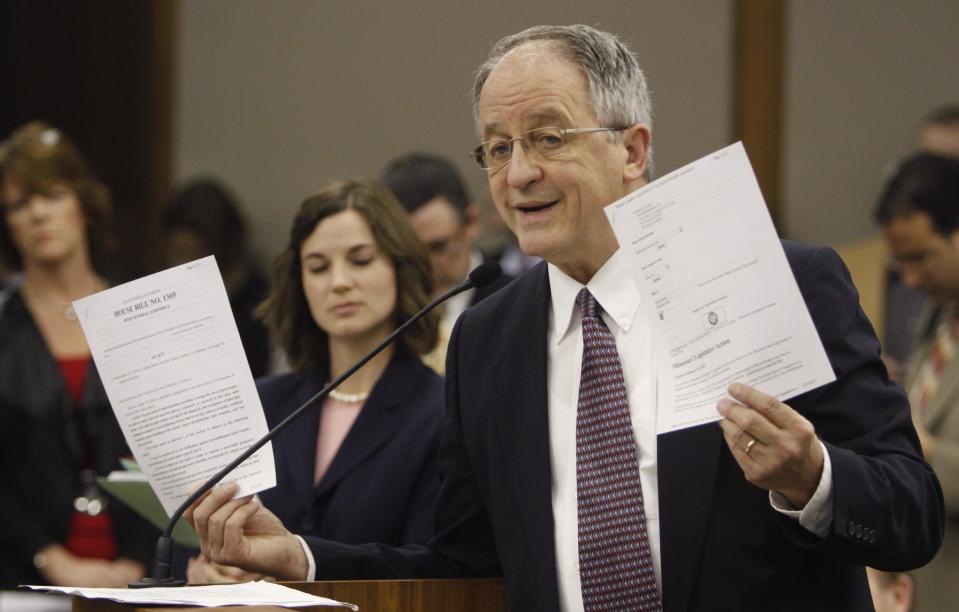 Del. Robert Marshall, R-Prince William, holds up papers during his presention on his Parenthood bill during a meeting of the Senate Education and Health committee at the Capitol in Richmond, Va., Thursday, Feb. 23, 2012. (AP Photo/Steve Helber)