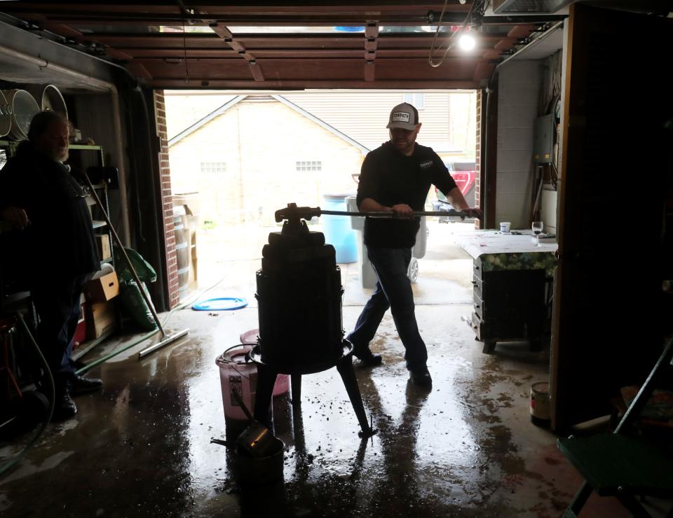 Anthony Piscazzi uses his great-grandfather's grape press in Cuyahoga Falls.