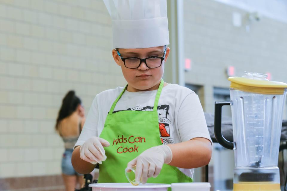 Carter Poe cooks during "Kids Can Cook" workshop on Thursday, Sept. 15, 2022, the first day of the Oklahoma State Fair in Oklahoma City.