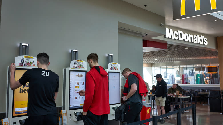 McDonald's customers using kiosks