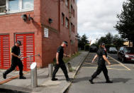 Police officers search a block of flats in Birmingham, Britain, August 15, 2018. REUTERS/Darren Staples