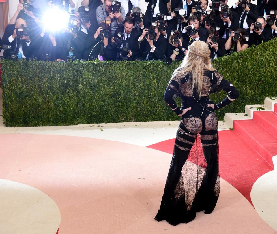 her back to the camera at the met, with her see through dress exposing her butt