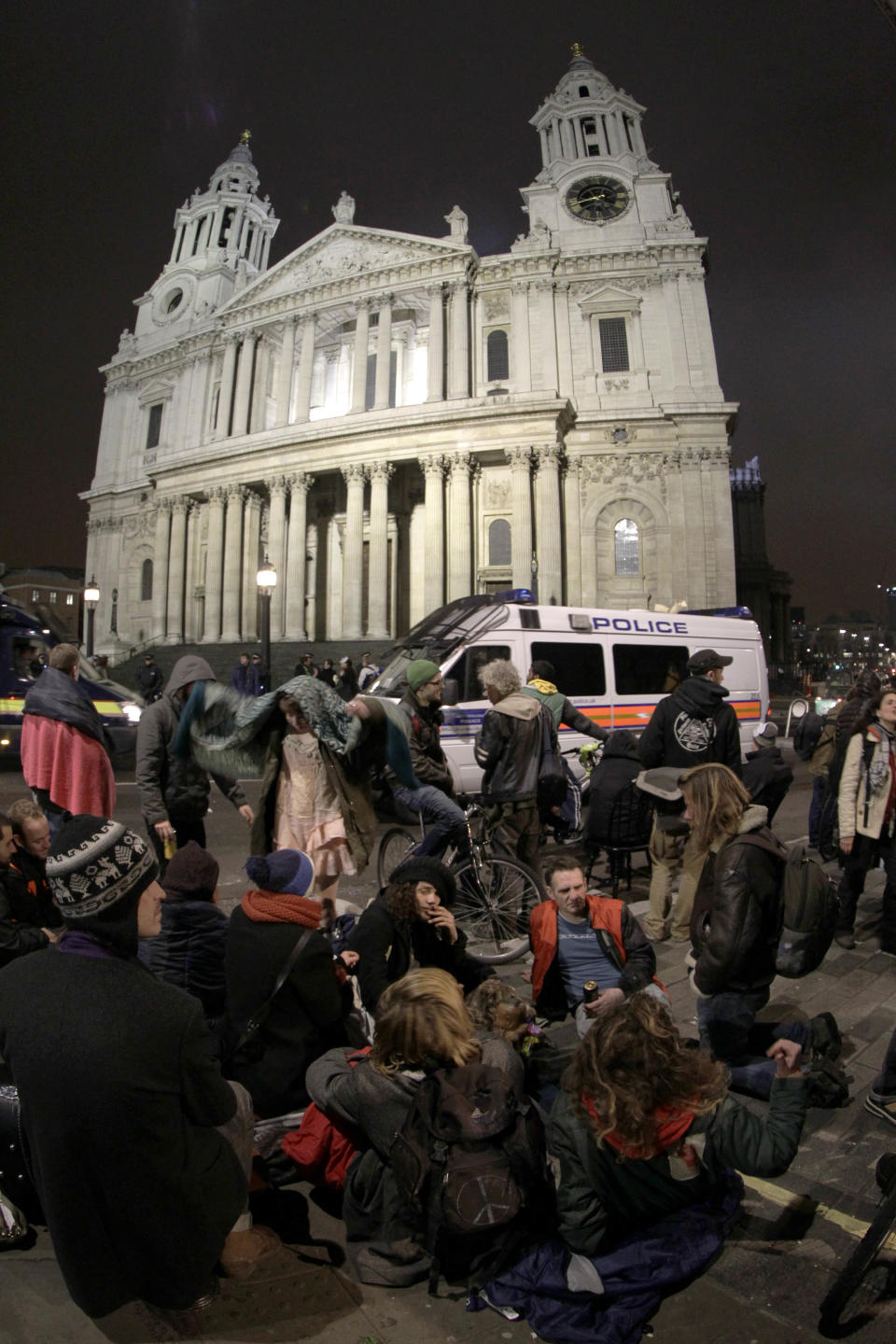 Taken with a fisheye lens, Occupy London protesters gather across from St Paul's Cathedral in London after bailiffs moved in to remove tents from the Occupy London camp, Tuesday, Feb. 28, 2012.  The anti-capitalist protest Occupy London camp was last week refused permission to appeal against a High Court decision to allow their eviction to proceed. (AP Photo/Sang Tan)