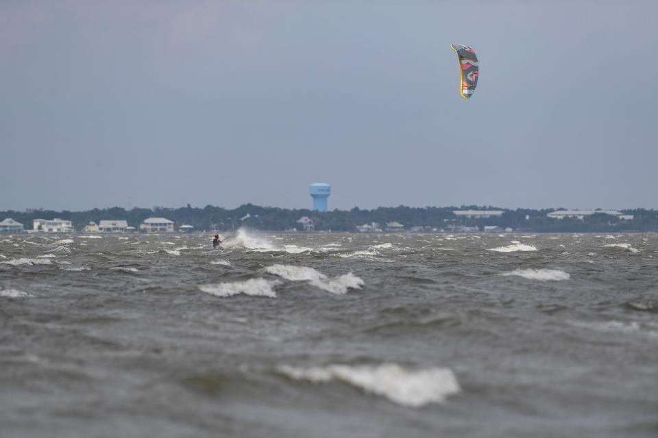 Erinc Akture, of Daytona Beach, takes advantage of the winds produced from Hurricane Idalia, Wednesday, Aug. 30, 2023, while he kite boards on the Indian River Lagoon just south of Sebastian Inlet State Park. "There is cleaner and safer wind here," Akture said adding they came south to avoid potentially dangerous weather north of Indian River County. Hurricane Idalia produced gusty winds on the Treasure Coast, but was overall spared of damage from the hurricane which briefly reached a category 4 overnight Tuesday.