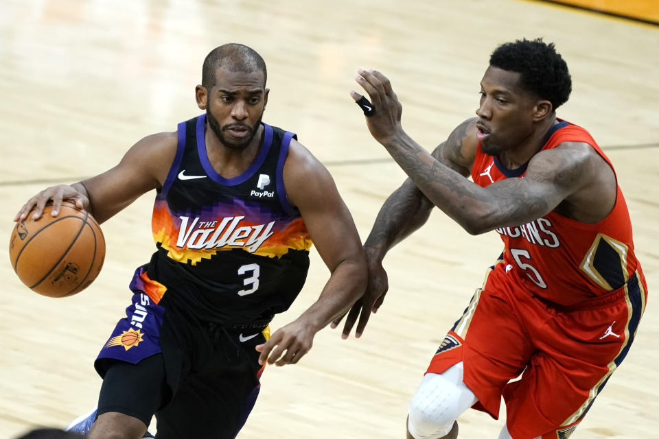 Phoenix Suns guard Chris Paul (3) drives on New Orleans Pelicans guard Eric Bledsoe during the second half of an NBA basketball game Tuesday, Dec. 29, 2020, in Phoenix. (AP Photo/Rick Scuteri)