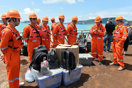 Chinese rescue workers prepare equipments before a search operation for missing passengers of a capsized tourist boat at a pier in Phuket, Thailand, July 7, 2018. (REUTERS)