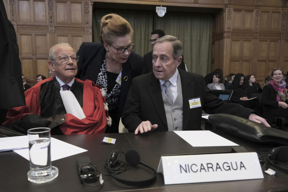 Nicaragua's Ambassador Carlos Jose Arguello Gomez, right, and Alain Pellet, lef, a lawyer representing Nicaragua, wait for the start of a two days hearing at the World Court in The Hague, Netherlands, Monday, April 8, 2024, in a case brought by Nicaragua accusing Germany of breaching the genocide convention by providing arms and support to Israel. (AP Photo/Patrick Post)