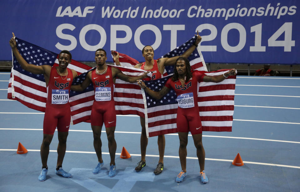United States' Calvin Smith, Kyle Clemons, Kind Butler III and David Verburg, from left, pose with American flags after winning the gold and setting a new indoor world record in the men's 4x400m relay final during the Athletics Indoor World Championships in Sopot, Poland, Sunday, March 9, 2014. (AP Photo/Matt Dunham)
