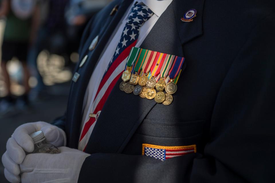 A Monterey County resident sits next to his truck during the 11th Annual Veteran's Day Parade in Salinas, in 2021.