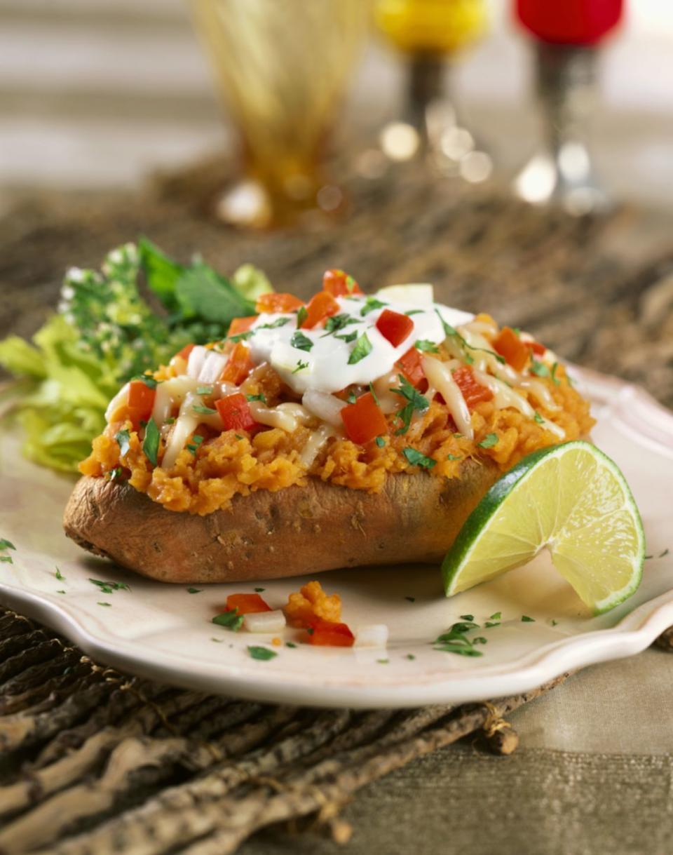 <p>Load one medium baked <a href="https://www.goodhousekeeping.com/food-recipes/easy/a42180/roasted-sweet-potato-and-chicken-salad-recipe/" rel="nofollow noopener" target="_blank" data-ylk="slk:sweet potato;elm:context_link;itc:0;sec:content-canvas" class="link ">sweet potato</a> with 1/4 cup canned navy beans (rinsed and drained), 1/4 cup salsa, 1/4 cup low-sodium cheese, 1/2 cup 0% Greek yogurt, 1/4 avocado, and 1 tablespoon of chopped chives.</p>