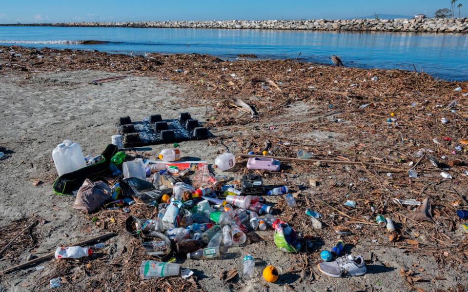 PHOTO:  Plastic bottles and other trash are piled up along the bank of the San Gabriel River just a few hundred yards from the Pacific Ocean in Seal Beach, CA, Dec. 13, 2022.  (Mark Rightmire/MediaNews Group via Getty Images)