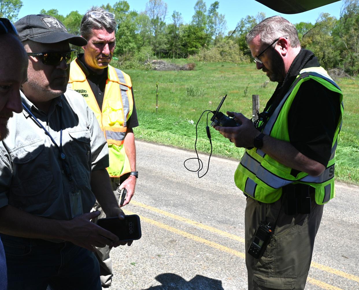 Meteorologist Todd Holston, Emergency Manager Tim Miner, and Branch County Sheriff drone operator Sgt. David Filmore survey the Arney Road tornado scene Wednesday morning.