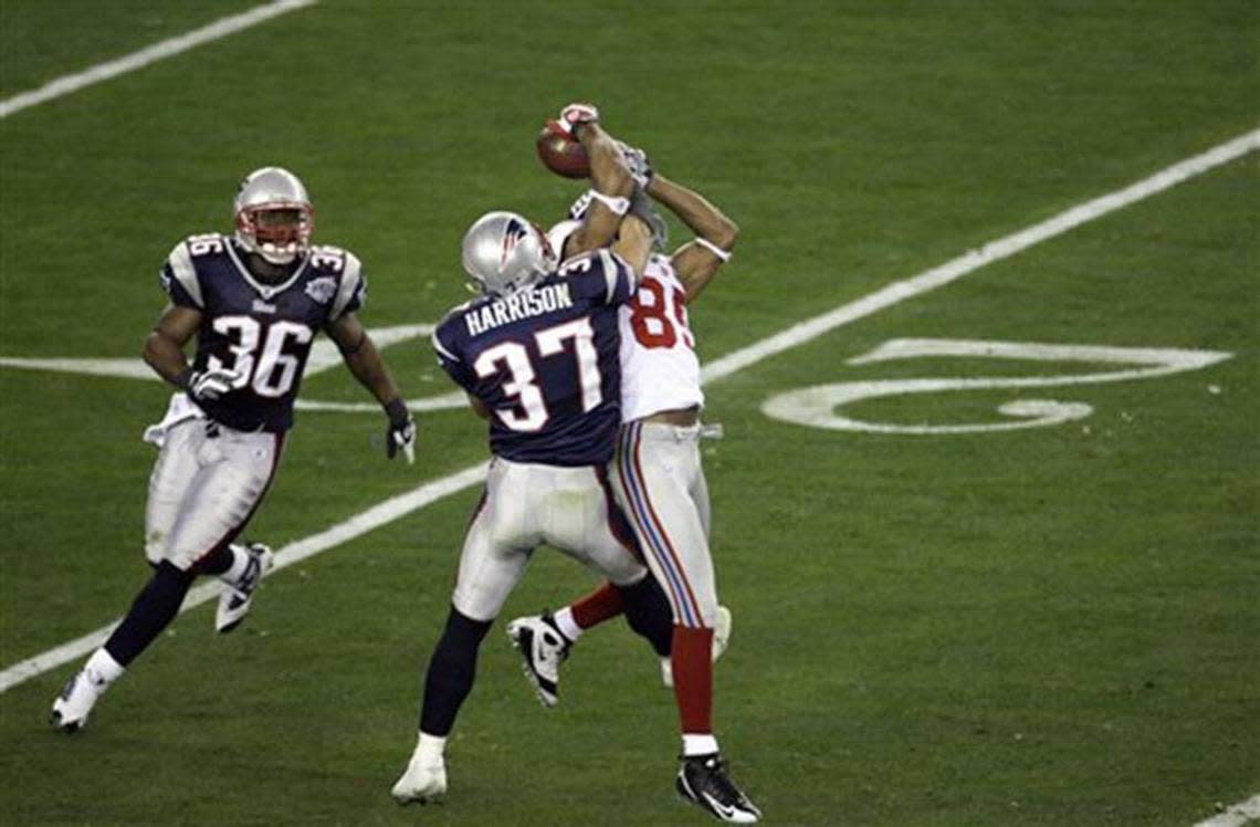 New York Giants David Tyree (85) makes a circus catch the New England Patriots’ Rodney Harrison defends during the Super Bowl XLII football game at University of Phoenix Stadium on Sunday, Feb. 3, 2008 in Glendale, Ariz. Eli Manning escaped pressure on the play and completed the 32-yard miracle pass to set up the Giants winning touchdown.