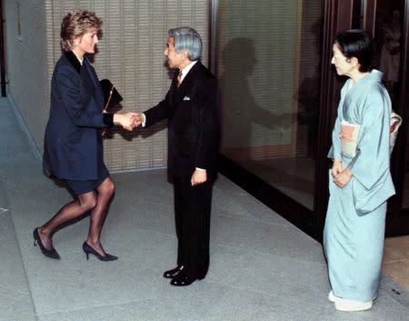 FILE PHOTO : Britain's Princess Diana (L) kneels as she is received by Emperor Akihito of Japan and Empress Michiko, in traditional kimono wear, on arrival for tea at the Imperial Palace as she wraps up a tour of Japan February 8, 1995. REUTERS/Stringer/File Photo