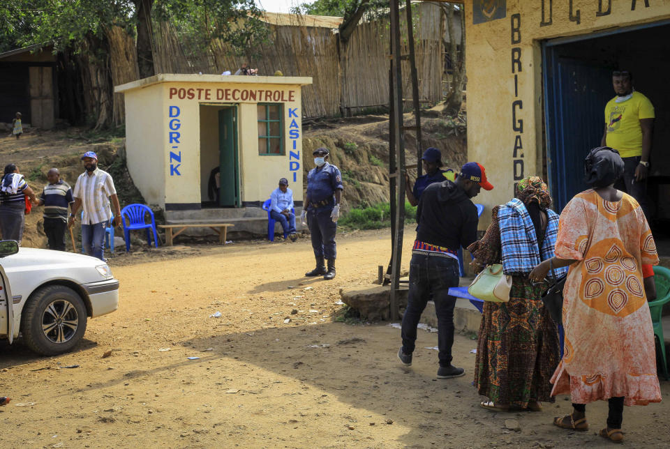 Police operate a checkpoint at the border crossing near Kasindi, eastern Congo Wednesday, June 12, 2019, just across from the Ugandan town of Bwera. In Uganda, a 5-year-old boy vomiting blood became the first cross-border victim of Ebola in the current outbreak on Wednesday, while two more people in Uganda tested positive for the highly contagious disease that has killed nearly 1,400 in Congo. (AP Photo/Al-hadji Kudra Maliro)