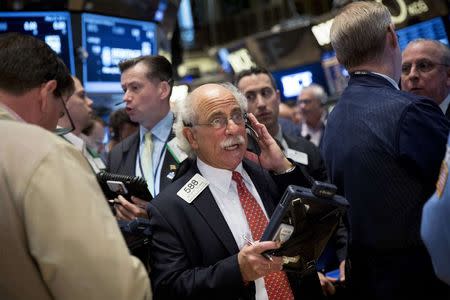 Traders work on the floor of the New York Stock Exchange May 23, 2014. REUTERS/Brendan McDermid