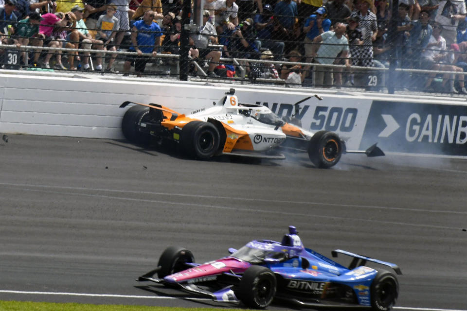 Felix Rosenqvist, top, of Sweden, hits the wall in the second turn during the Indianapolis 500 auto race at Indianapolis Motor Speedway in Indianapolis, Sunday, May 28, 2023. (AP Photo/Greg Huey)