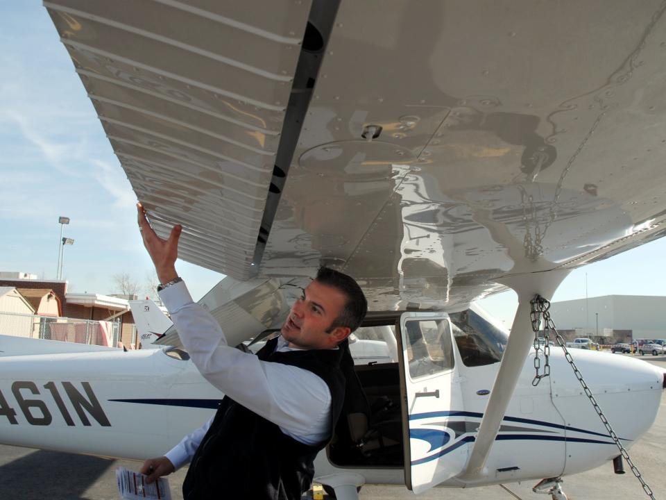 Chief flight instructor for McAir Aviation, Justin Wigal performs a preflight inspection on a Cessna 172.