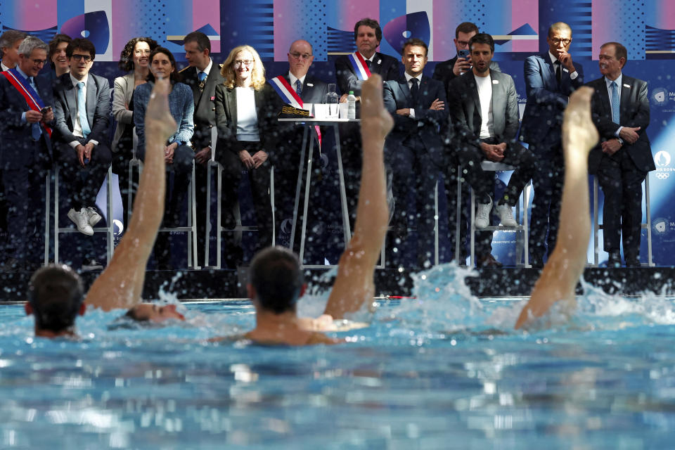 French President Emmanuel Macron, center, and officials attend the inauguration of the Olympic Aquatics Center (CAO) in Saint-Denis, near Paris, Thursday, April 4, 2024. The aquatic center will host the artistic swimming, water polo and diving events during the Paris 2024 Olympic Games. (Gonzalo Fuentes/Pool via AP)