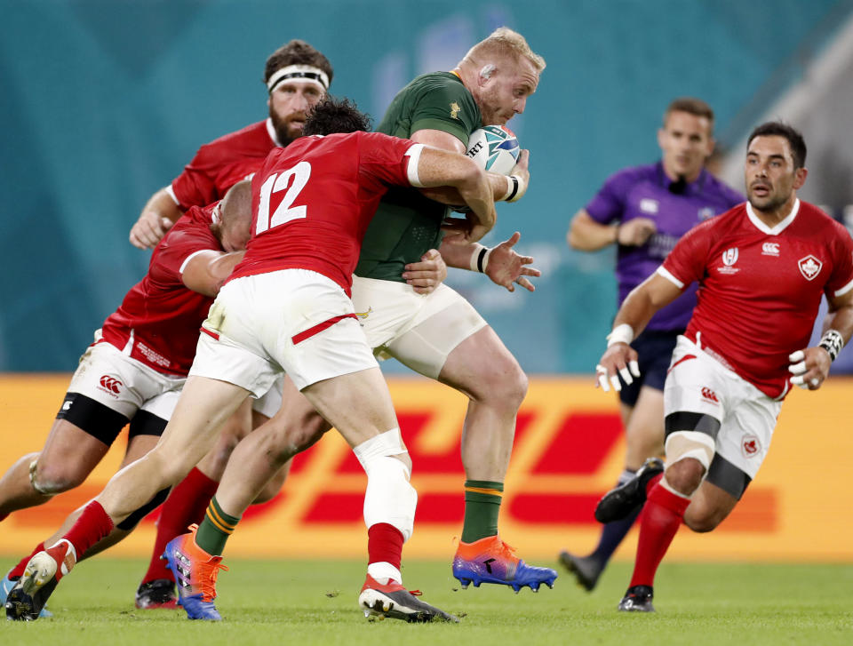 South Africa's Vincent Koch is tackled by Canada's Ciaran Hearn during the Rugby World Cup Pool B game at Kobe Misaki Stadium between South Africa and Canada in Kobe, Japan, Tuesday, Oct. 8, 2019. (Kyodo News via AP)