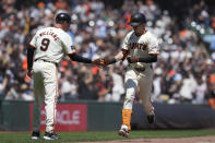 San Francisco Giants' Mike Yastrzemski, right, celebrates with third base coach Matt Williams after hitting a solo home run off Pittsburgh Pirates pitcher Jared Jones during the third inning of a baseball game Sunday, April 28, 2024, in San Francisco. (AP Photo/Godofredo A. Vásquez)