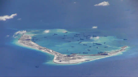 Chinese dredging vessels are purportedly seen in the waters around Mischief Reef in the disputed Spratly Islands in the South China Sea, May 21, 2015. REUTERS/U.S. Navy