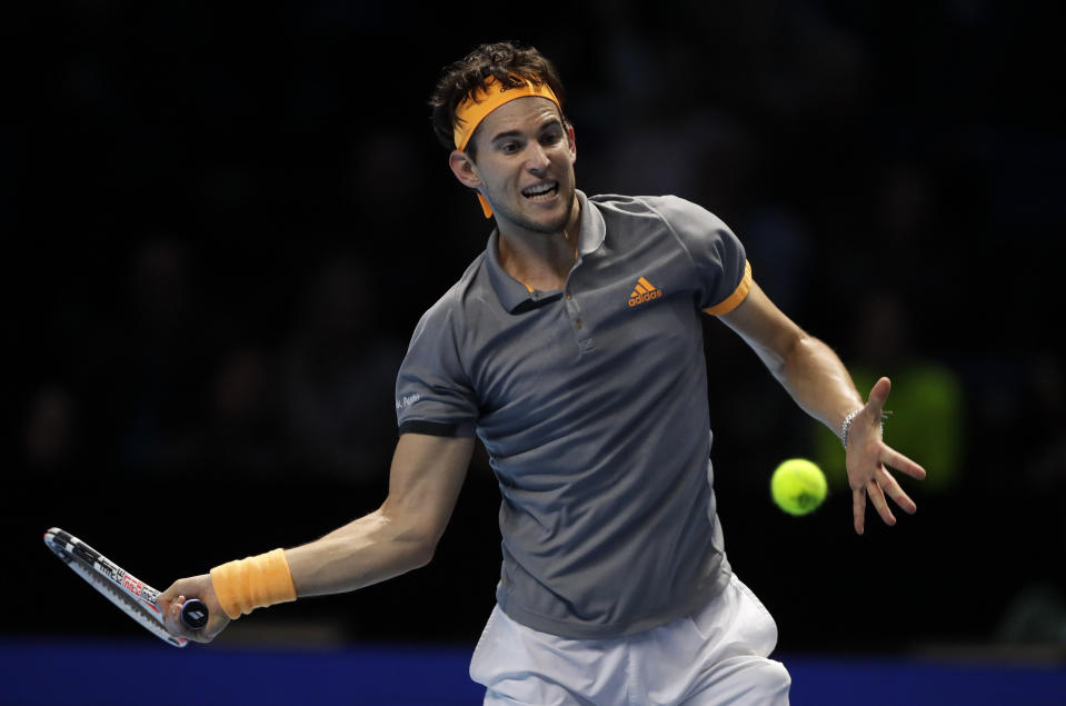 Dominic Thiem of Austria plays a return to Alexander Zverev of Germany during their ATP World Tour Finals semifinal tennis match at the O2 Arena in London, Saturday, Nov. 16, 2019. (AP Photo/Kirsty Wigglesworth)