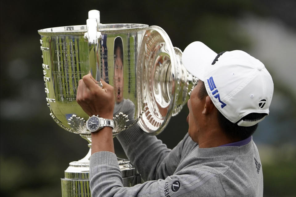 Collin Morikawa reacts as the top of the Wanamaker Trophy falls after winning the PGA Championship golf tournament at TPC Harding Park Sunday, Aug. 9, 2020, in San Francisco. (AP Photo/Charlie Riedel)