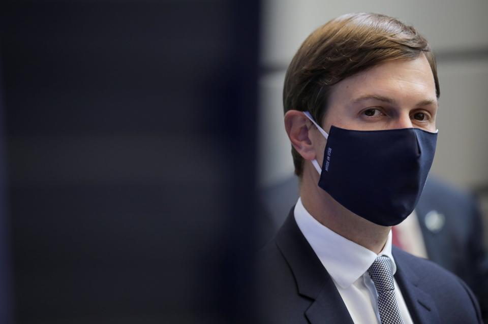 Jared Kushner watches, masked, as Donald Trump delivers a speech: REUTERS