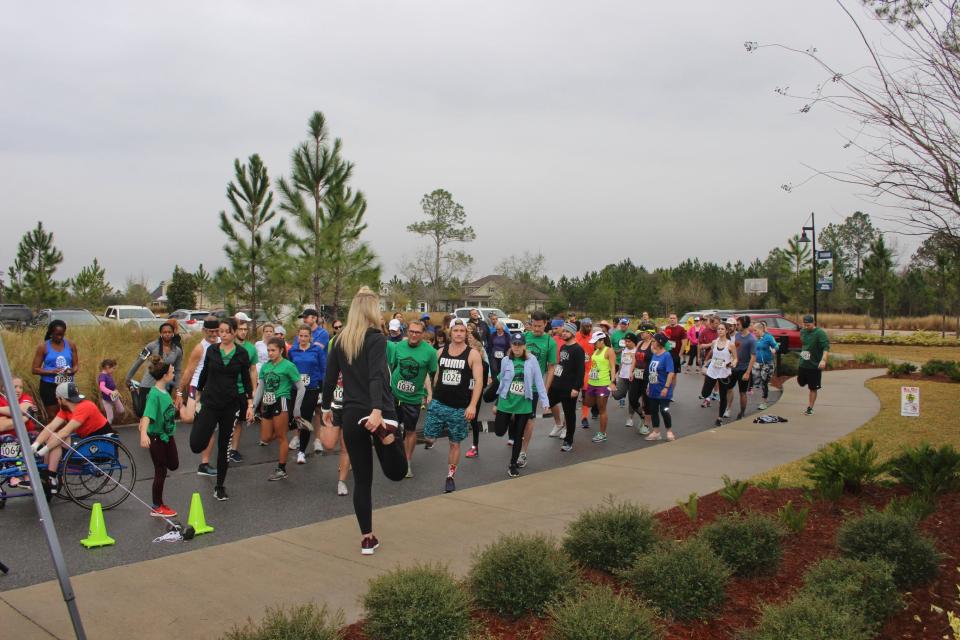 Participants warm up prior to the 2019 Conquer the Trails event at TrailMark in St. Johns County. The fundraising race returns on Feb. 19.