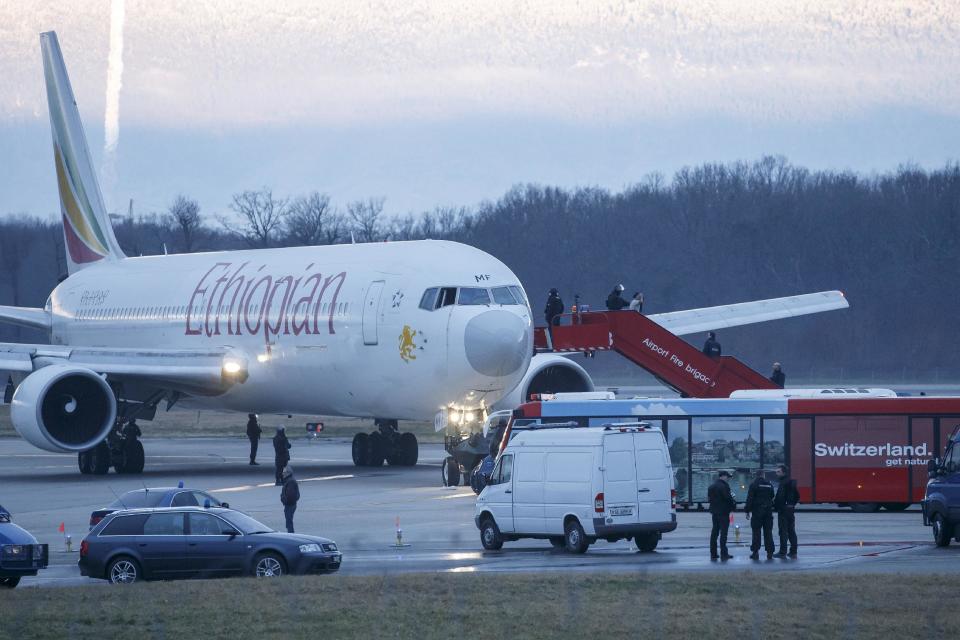 Passengers are evacuated from a hijacked Ethiopian Airlines Plane on the airport in Geneva, Switzerland, Monday, Feb. 17, 2014. A hijacked aircraft traveling from Addis Abeda, Ethiopia, to Rome, Italy, has landed at Geneva's international airport early Monday morning. Swiss authorities have arrested the hijacker. (AP Photo/Keystone, Salvatore Di Nolfi)